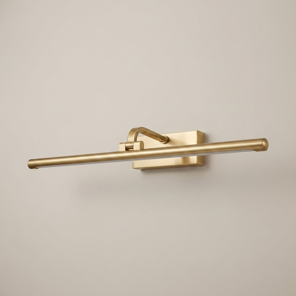 Gold battery wall light on a clean studio background