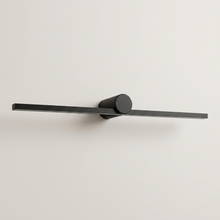 Black battery wall light on a clean studio background