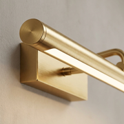 Close-up of the gold finish and frame detail of the wall light