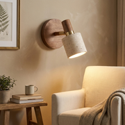 Walnut travertine reading wall light beside an armchair in a warm living room