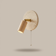 Rotatable travertine wall light in Light Wood finish on a clean studio background