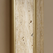 Close-up of travertine texture and gold trim on a Winchester wall light