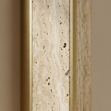 Close-up of travertine texture and gold trim on a Winchester wall light