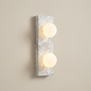 Holland white marble wall light with two glass globes on a clean background