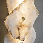 Close-up of alabaster texture and brass accent dot on a Radley wall light