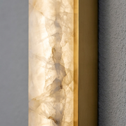 Close-up of alabaster texture and gold edge trim on an Eaton outdoor wall light