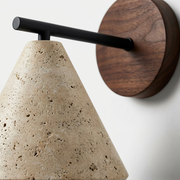 Close-up of travertine cone shade and walnut backplate on a Stratford wall light