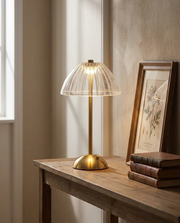 Acrylic dome cordless table lamp glowing on a wooden console table