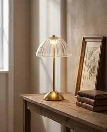 Acrylic dome cordless table lamp glowing on a wooden console table