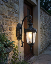 Black large glass lantern outdoor wall light beside a front door