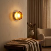 Lumiere Glass Wireless Wall Sconce - amber glass, in a living room