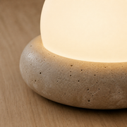 Close-up of the Huxley porous cream stone base and frosted light dome