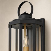 Close-up of the Islington matte-black frame, clear glass, loop crown and brass candle light