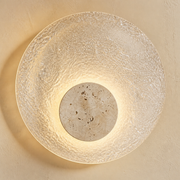 Close-up of the Langham textured clear acrylic disc and pale travertine-style stone centre