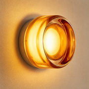 Close-up of the Lumiere amber glass ring, luminous centre and round wall base