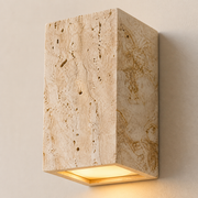 Close-up of the Meridian porous travertine-style stone and recessed downlight diffuser