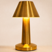 Close-up of the Mila brushed-gold shade, tapered body and round stepped base