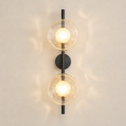 Moreton two-light wireless wall sconce in the satin-black finish with clear textured glass discs