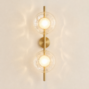 Moreton two-light wireless wall sconce in the brushed-gold finish with clear textured glass discs