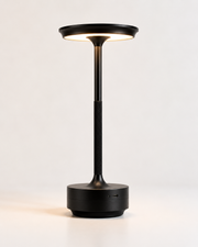 Pembroke metal cordless table lamp in black with disc shade and knurled stem, lit