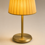 Close-up of the Pimlico soft pleated golden fabric shade, slim brushed-gold stem, shallow base and touch control
