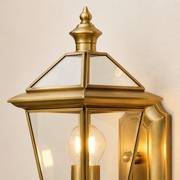 Close-up of the Portobello aged-brass finial, roof moulding, clear glass and decorative backplate