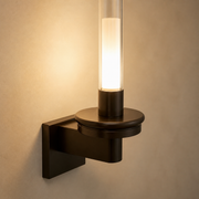 Close-up of the Primrose black canopy, arm, circular plate, clear glass tube and warm diffuser