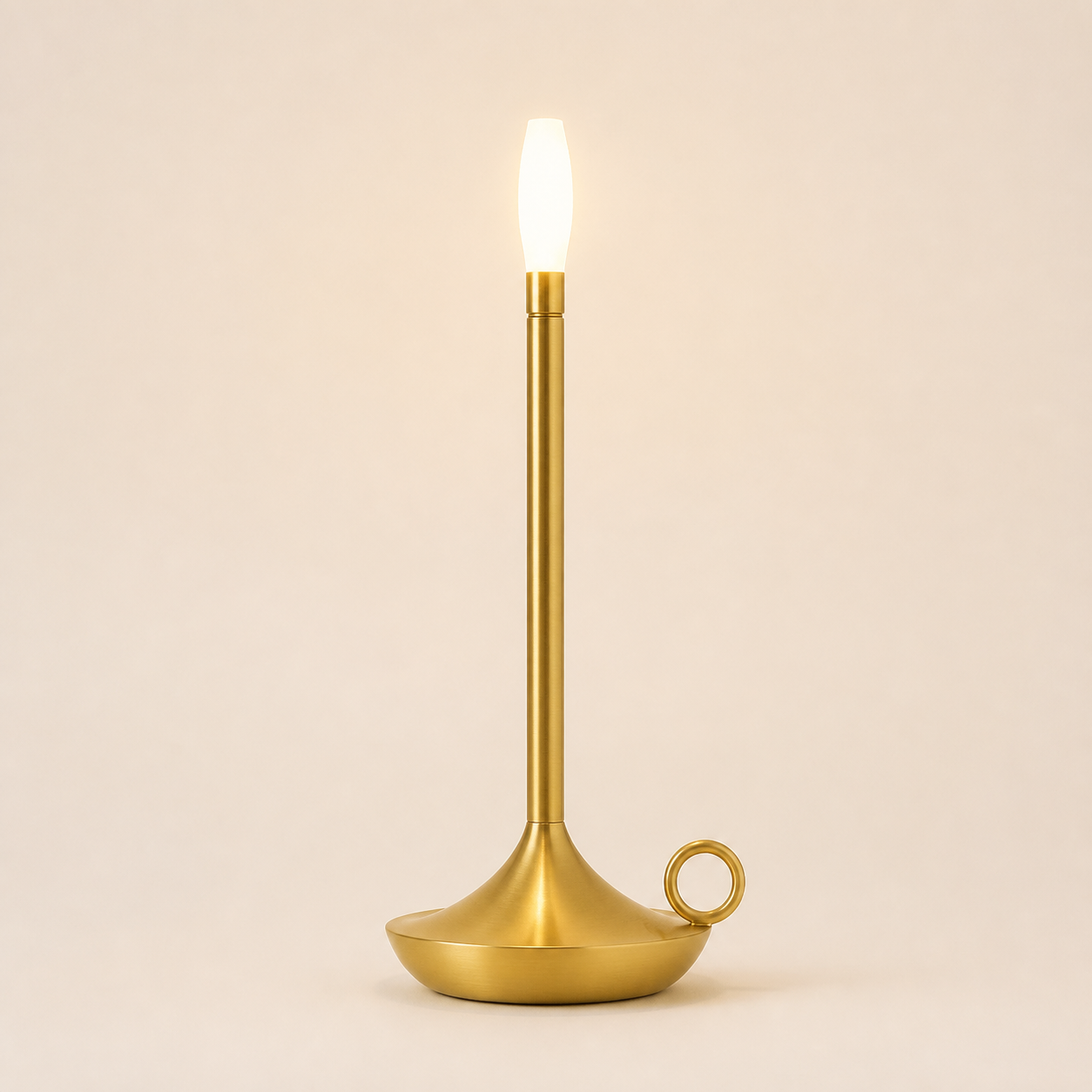 Rowan cordless table lamp in the brushed-gold finish with flame-shaped diffuser and looped base