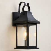 Close-up of the Soho black lantern's twin top loops, flared roof, glass panels and wall mount