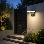Windsor solar outdoor wall light illuminating a contemporary side gate and garden steps at dusk