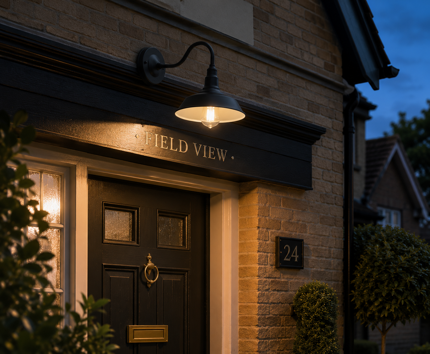 Black Wren gooseneck outdoor light glowing above a UK front door at dusk